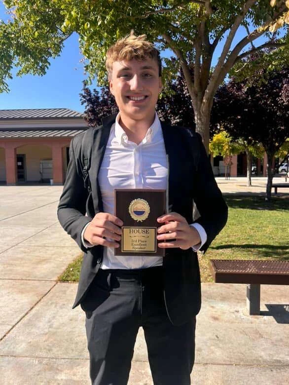 Sammy holding his third-place House debate award